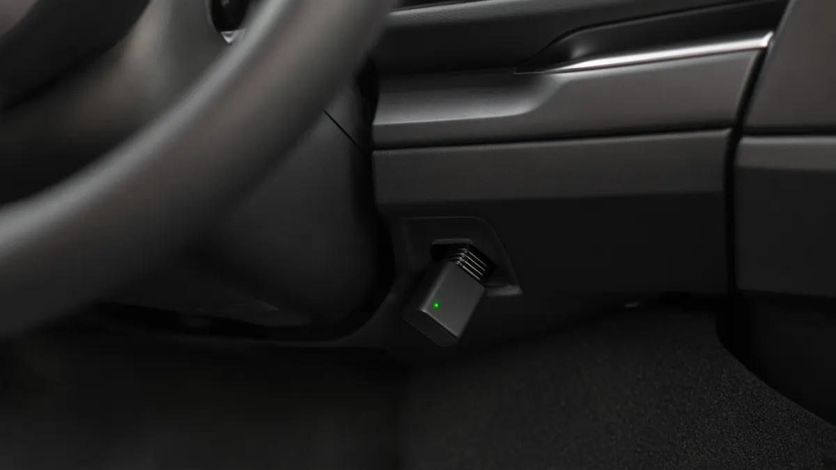 JamGuard car unit plugged into the OBD-II port under a dashboard